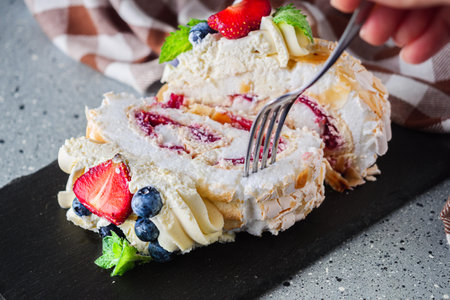 Delicate Meringue Roulade with Blueberries, Strawberries, and Mascarpone Cream.の写真素材