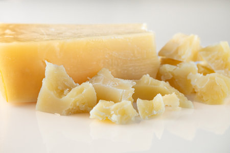 Authentic Italian Parmigiano Reggiano: Aged Cheese Wedge Isolated on White Background.の写真素材