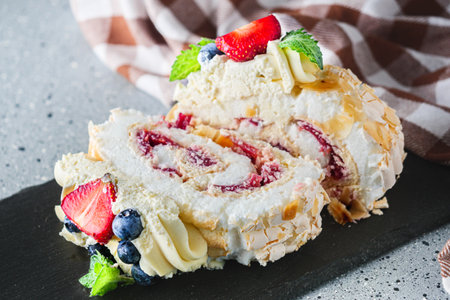 Delicate Meringue Roulade with Blueberries, Strawberries, and Mascarpone Cream.の写真素材
