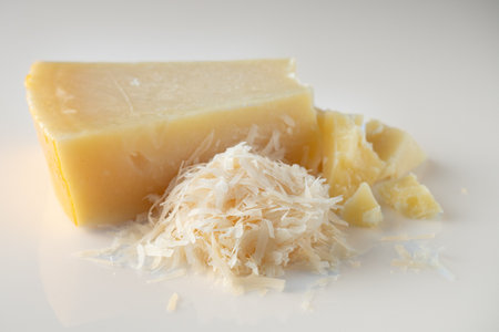 Authentic Italian Parmigiano Reggiano: Aged Cheese Wedge Isolated on White Background.