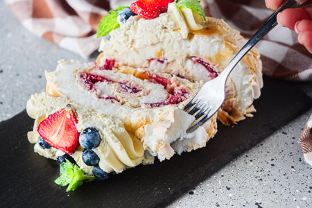 Delicate Meringue Roulade with Blueberries, Strawberries, and Mascarpone Cream.の写真素材