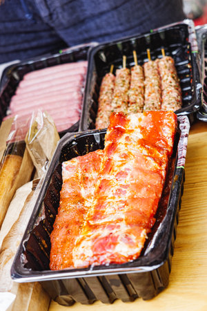Sizzling BBQ Feast: Grilled Meats and Sausages at a Vibrant Summer Food Festival.の写真素材