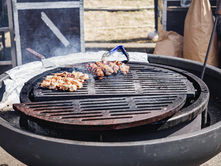 Grilling Meat at a BBQ Festival: A Close-Up of Delicious Street Food.の写真素材