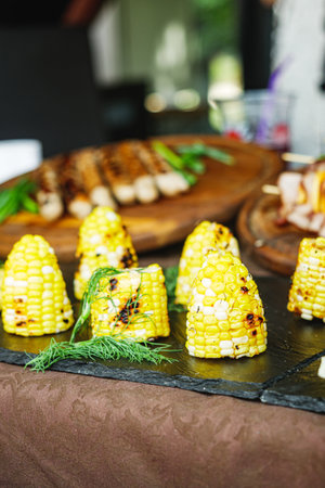 Grilled Street Food Feast: Fresh and Healthy Barbecue with Corn, Sausages, and Salad at a Vibrant Summer Event.の写真素材