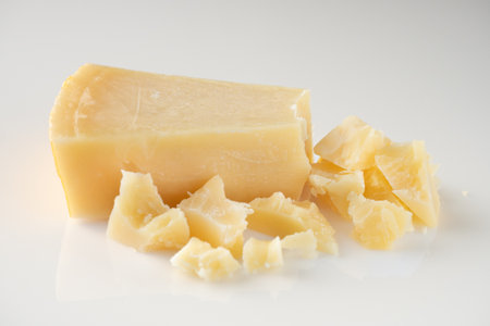Authentic Italian Parmigiano Reggiano: Aged Cheese Wedge Isolated on White Background.の写真素材