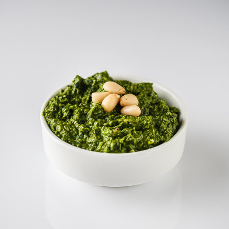 Homemade Pesto Sauce with Pine Nuts and Basil: Ingredients on White Background.の写真素材