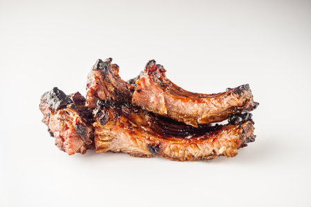 White Isolated Grilled BBQ Ribs with Red Sauce Pork and Beef Roasted on Charcoal Gourmet Meal.の写真素材