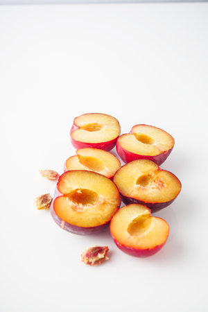 Isolated Summer Plums: Fresh and Juicy Red and Black Plums on a White Background.の写真素材