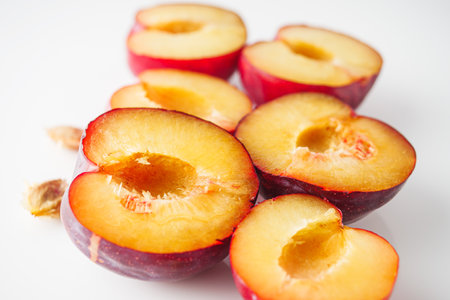 Isolated Summer Plums: Fresh and Juicy Red and Black Plums on a White Background.の写真素材