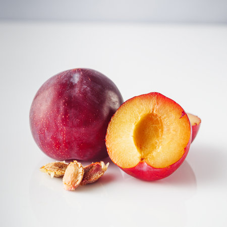 Isolated Summer Plums: Fresh and Juicy Red and Black Plums on a White Background.の写真素材