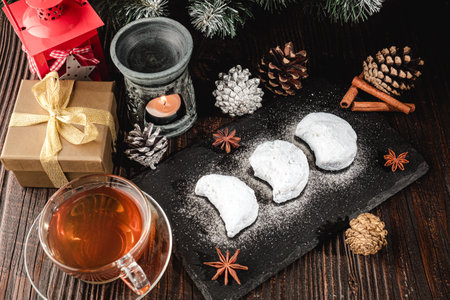 Traditional Greek Kourabiedes with Christmas Decorations: Festive Holiday Cookies on a Rustic Wooden Table.の写真素材