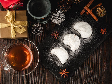 Traditional Greek Kourabiedes with Christmas Decorations: Festive Holiday Cookies on a Rustic Wooden Table.の写真素材