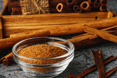 Closeup of Aromatic Ground Cinnamon and Sticks on a White Background.の写真素材