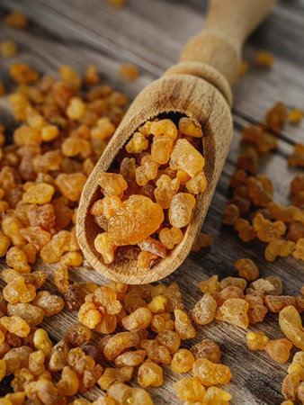 Natural Aromatic Frankincense and Myrrh Resin with Wooden Spoon on Rustic Table.の写真素材