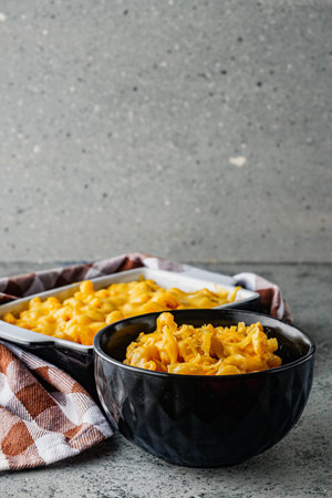 Delicious Homemade Cheddar Mac and Cheese in a Bowl with Creamy Sauce and Tasty Noodles.の写真素材