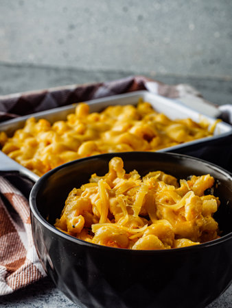 Delicious Homemade Cheddar Mac and Cheese in a Bowl with Creamy Sauce and Tasty Noodles.の写真素材