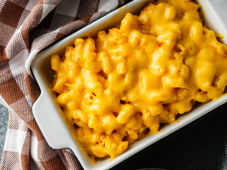 Delicious Homemade Cheddar Mac and Cheese in a Bowl with Creamy Sauce and Tasty Noodles.の写真素材