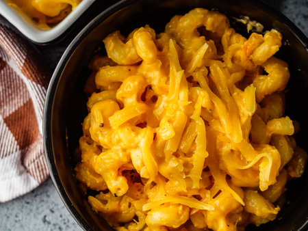 Delicious Homemade Cheddar Mac and Cheese in a Bowl with Creamy Sauce and Tasty Noodles.の写真素材