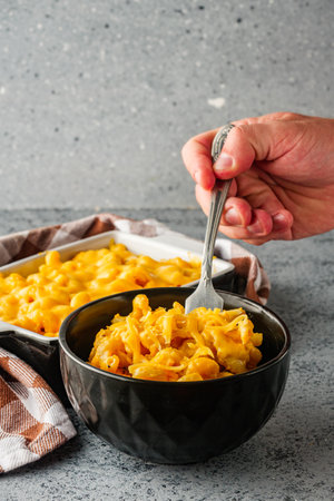 Delicious Homemade Cheddar Mac and Cheese in a Bowl with Creamy Sauce and Tasty Noodles.の写真素材