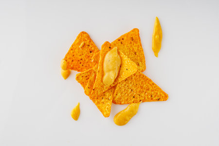 Crunchy Cheese Nachos with Spicy Chilli on a White Background Perfect for Snack Time.の写真素材
