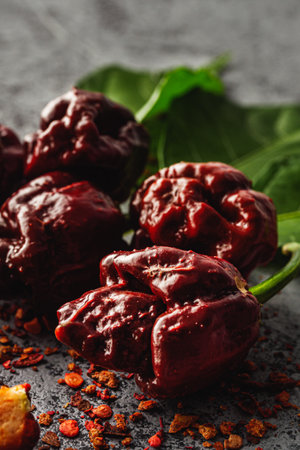 Variety of Spicy Peppers Including Aji Limo, Habanero, and Carolina Reaper on a Vibrant Background.の写真素材