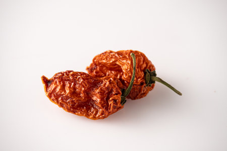 Fresh and Dried Habanero and Chili Peppers with Capsicum and Yellow Pickled Paprika on White...