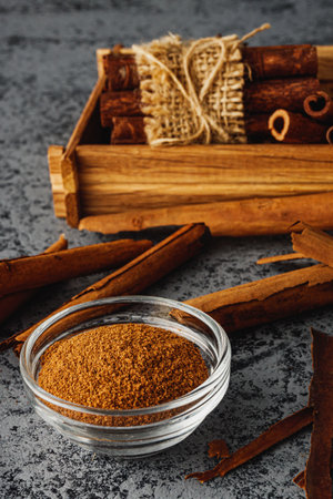 Closeup of Aromatic Ground Cinnamon and Sticks on a White Background.の写真素材