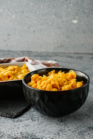 Delicious Homemade Cheddar Mac and Cheese in a Bowl with Creamy Sauce and Tasty Noodles.の写真素材