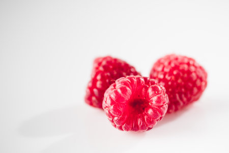 Fresh Raspberries: Juicy, Ripe Berries for a Healthy Summer Snack on a white background.