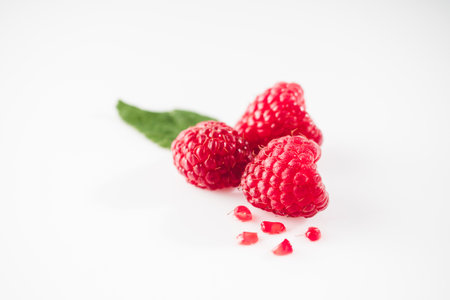 Fresh Raspberries: Juicy, Ripe Berries for a Healthy Summer Snack on a white background.
