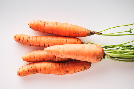 Fresh Carrot Juice Isolated on White with Organic Orange Carrots Healthy Vegetarian and Delicious.の写真素材