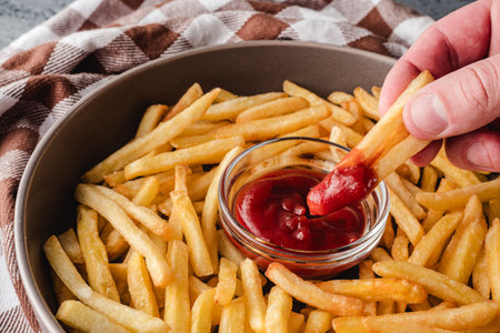 Crispy French Fries with Ketchup, Golden and Tasty Fast Food Snack, Salted and Crunchy Potato Chips.の写真素材