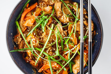 Wok Chicken with Funchoza and Vegetables, Asian Stir-Fry Delight, Tasty and Healthy Gourmet Dish.の写真素材
