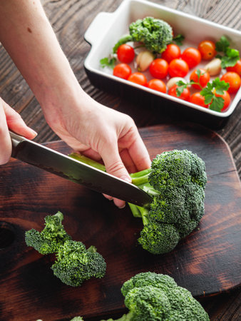 Young Woman Preparing Fresh Broccoli, Rustic Cooking.の写真素材