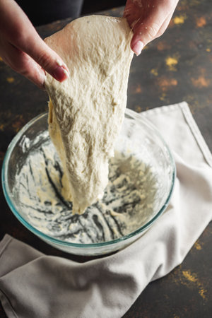 Young woman Making Homemade Focaccia Bread Traditional Italian Recipe.の写真素材