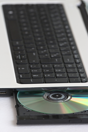 close-up on a cd dvd burner drive inside a laptopの写真素材