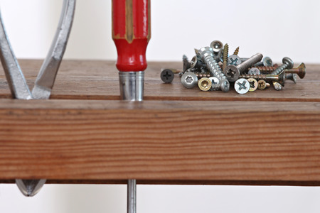 close up of a screwdriver and screws Stored in a wooden cabinet