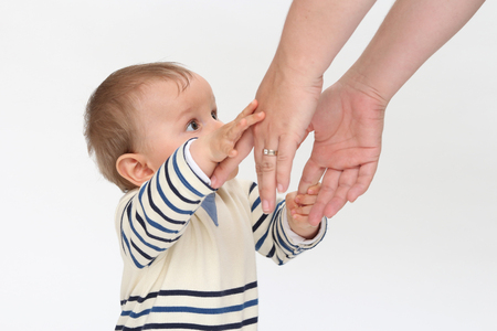 babe stretches arms to momの写真素材