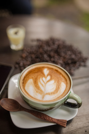 Latte Art coffee with coffee beanの写真素材
