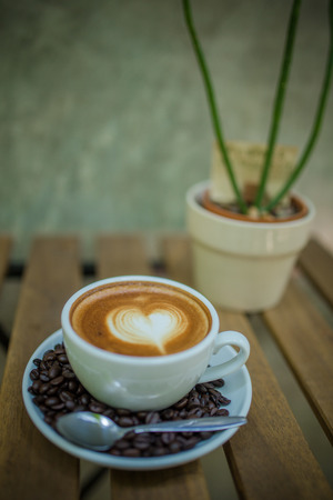 Latte Art coffee with coffee beanの写真素材