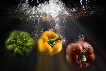 vegetables splash water on black backgroundの写真素材