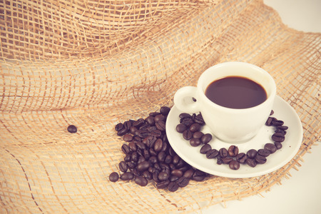 Coffee cup and beans on a white background vintage colorの写真素材