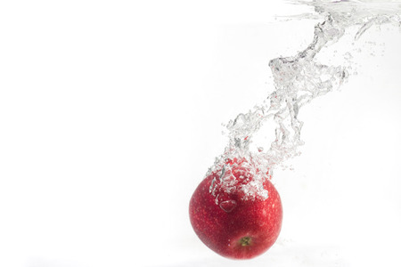red apple splash waterの写真素材