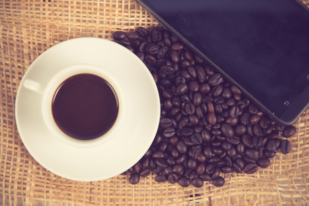 Coffee cup and beans on a white background vintage colorの写真素材