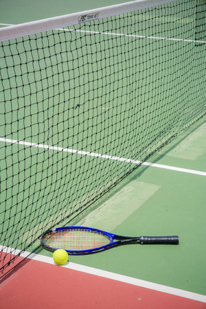 tennis racket and balls on the tennis courtの写真素材