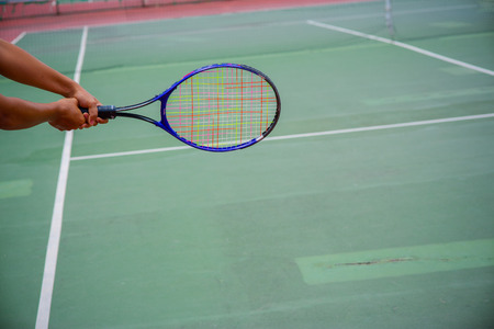 tennis racket and balls on the tennis courtの写真素材