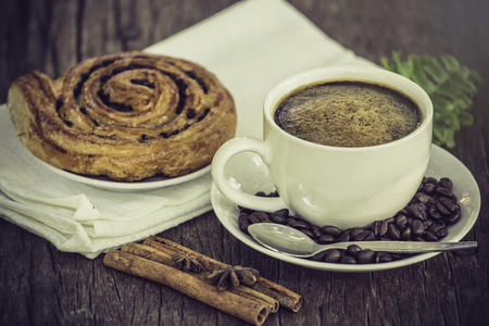 Coffee cup with a croissant on vintage wooden tableの写真素材