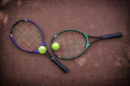 tennis racket and balls on the tennis courtの写真素材