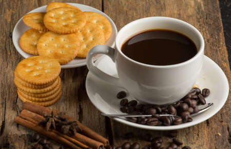 Cup of coffee on a wooden board and biscuitsの写真素材