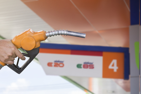 Holding a fuel nozzleの写真素材